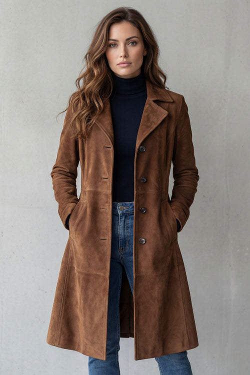 Full-length front view of a woman wearing a tan brown tailored longline coat with five-button closure and A-line skirt