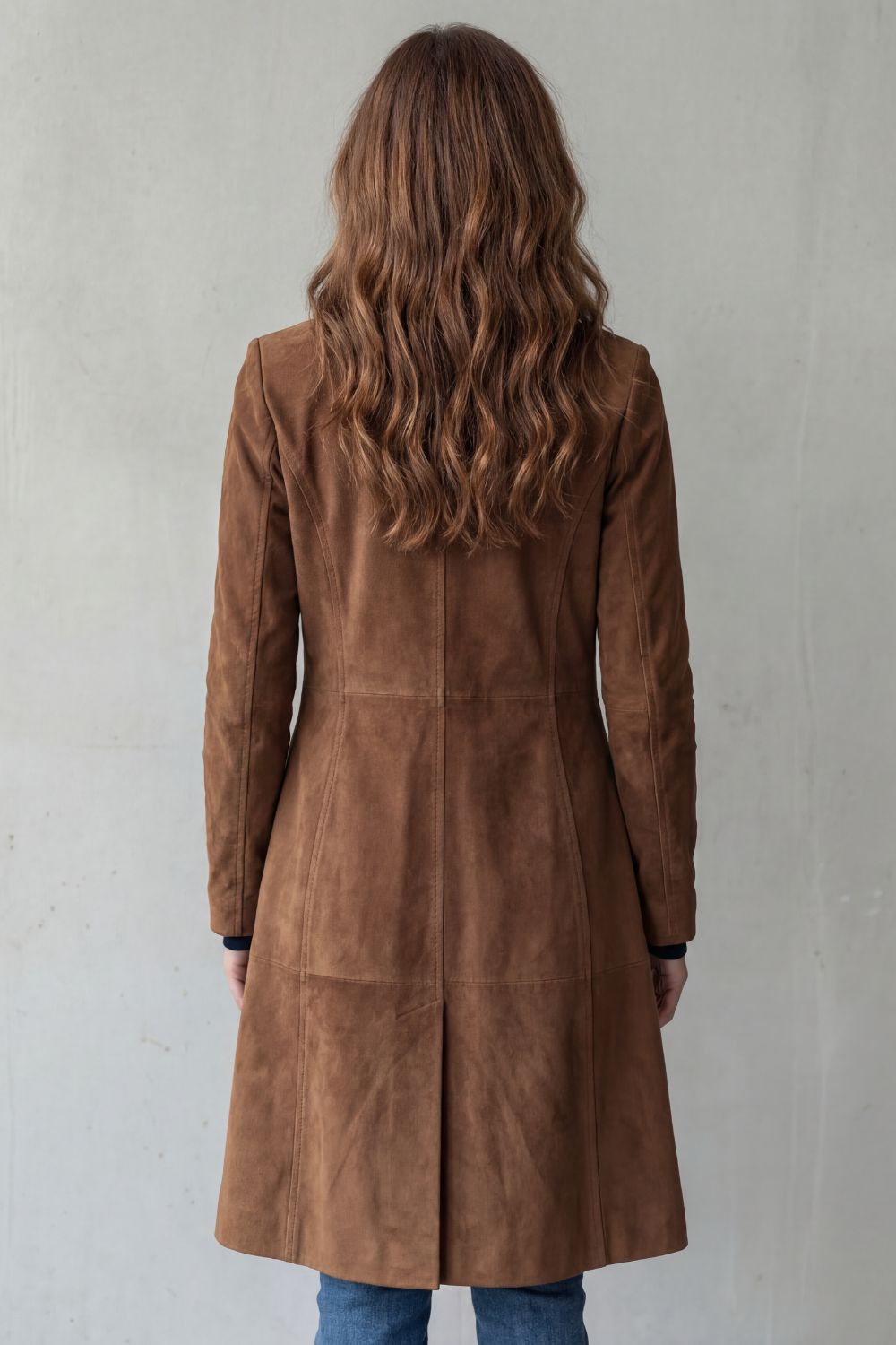 Rear view of the tan brown longline coat showing princess seam panelling and centre back vent