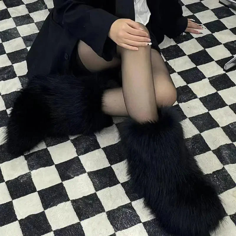 Model seated on a checkered floor wearing black fluffy fur boots, side and angled view