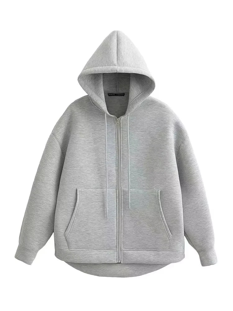 Oversized zip-up hoodie in light grey showing full-length zipper, kangaroo pockets and curved hem, flat lay front view