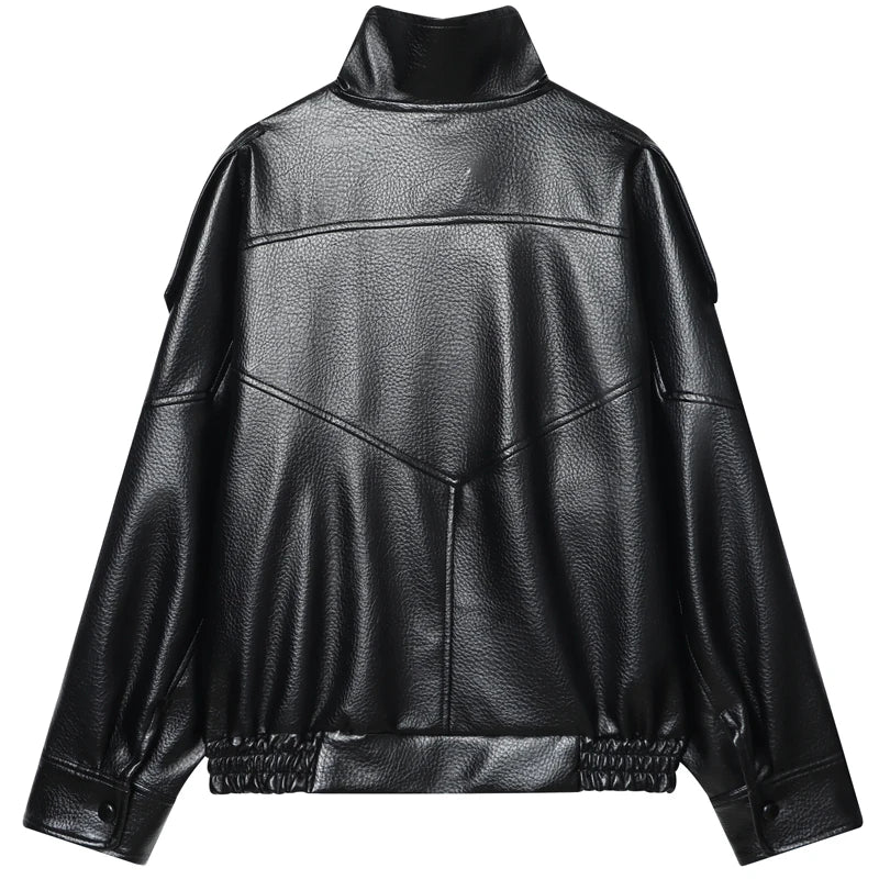 Back flat lay of the black oversized cropped moto jacket showing geometric topstitched seam panels and ruched elasticated hem