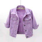 Cropped lavender denim jacket with pointed lapels, chest flap pockets and rolled cuffs, displayed on a hanger